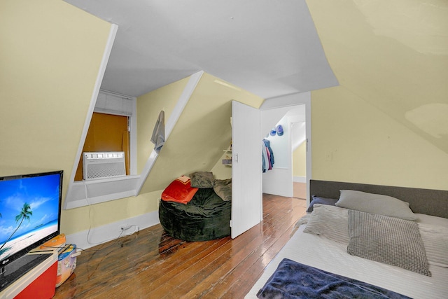 bedroom featuring hardwood / wood-style flooring and vaulted ceiling