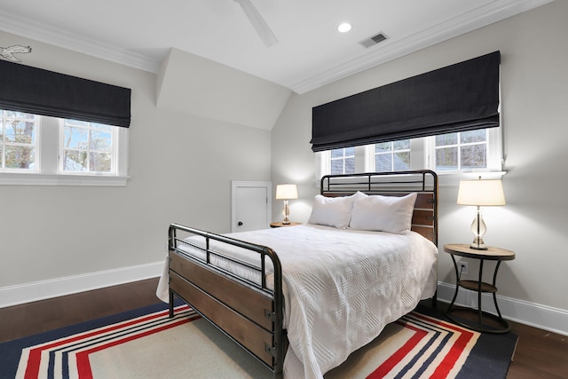 bedroom featuring dark hardwood / wood-style flooring, ornamental molding, and ceiling fan