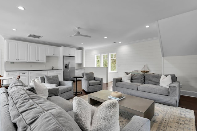 living room featuring crown molding, sink, ceiling fan, and dark hardwood / wood-style flooring