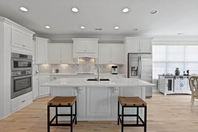 1216 Rivers Reach Dr, Charleston, SC 29492 - kitchen featuring stainless steel appliances, a sink, crown molding, a kitchen breakfast bar, and a kitchen island with sink