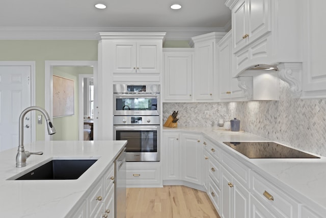 1216 Rivers Reach Dr, Charleston, SC 29492 - kitchen with a sink, stainless steel appliances, white cabinets, light wood-style floors, and ornamental molding