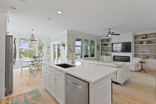 1216 Rivers Reach Dr, Charleston, SC 29492 - kitchen with appliances with stainless steel finishes, a sink, ceiling fan, white cabinets, and light wood finished floors