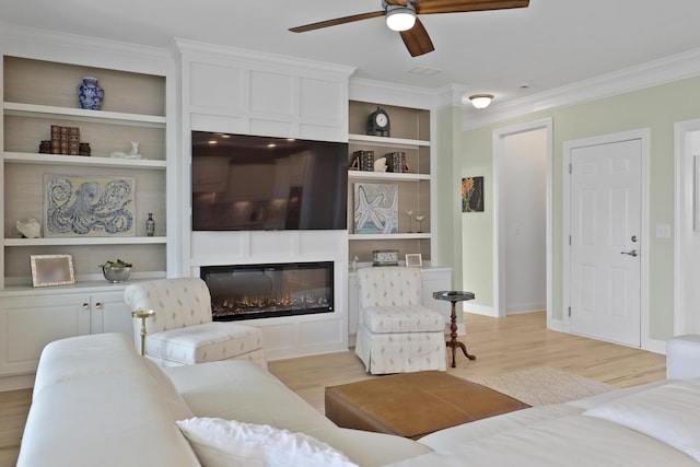 1216 Rivers Reach Dr, Charleston, SC 29492 - living area featuring crown molding, a ceiling fan, light wood finished floors, a glass covered fireplace, and built in features