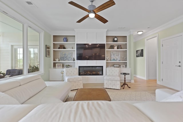 1216 Rivers Reach Dr, Charleston, SC 29492 - living area featuring a ceiling fan, crown molding, built in features, wood finished floors, and a large fireplace