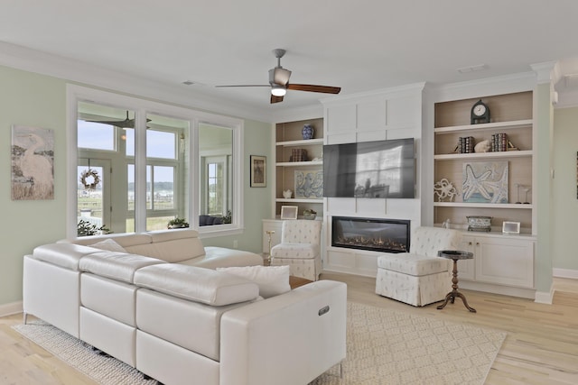1216 Rivers Reach Dr, Charleston, SC 29492 - living area with ceiling fan, light wood finished floors, a fireplace, baseboards, and crown molding