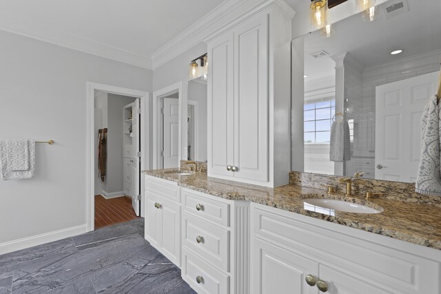 1216 Rivers Reach Dr, Charleston, SC 29492 - bathroom with crown molding, double vanity, baseboards, ornate columns, and a tile shower