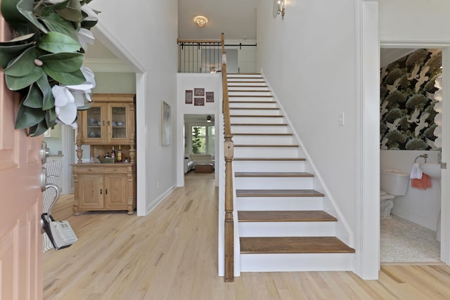 1216 Rivers Reach Dr, Charleston, SC 29492 - stairway with a barn door, wood finished floors, a towering ceiling, and baseboards