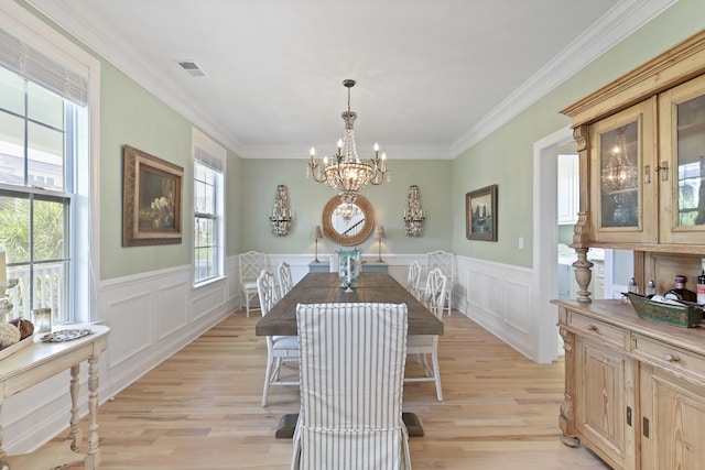 1216 Rivers Reach Dr, Charleston, SC 29492 - dining area featuring plenty of natural light, a chandelier, light wood finished floors, crown molding, and wainscoting