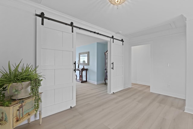 1216 Rivers Reach Dr, Charleston, SC 29492 - spare room with a barn door, attic access, baseboards, and light wood-type flooring