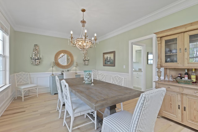 1216 Rivers Reach Dr, Charleston, SC 29492 - dining space featuring light wood finished floors, ornamental molding, a chandelier, wainscoting, and a decorative wall