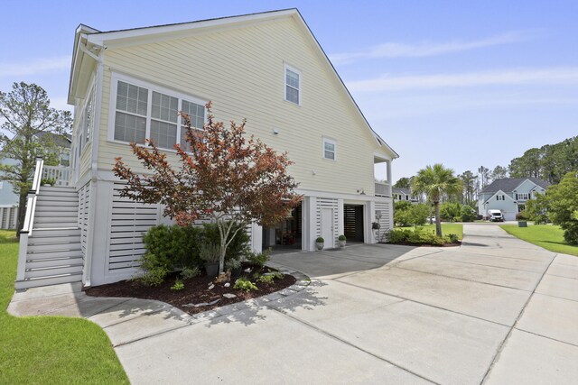 1216 Rivers Reach Dr, Charleston, SC 29492 - view of property exterior featuring stairs, concrete driveway, and a carport