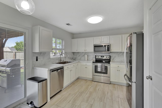 7838 Long Shadow Ln, North Charleston, SC 29406 - kitchen featuring stainless steel appliances, a sink, light countertops, and backsplash