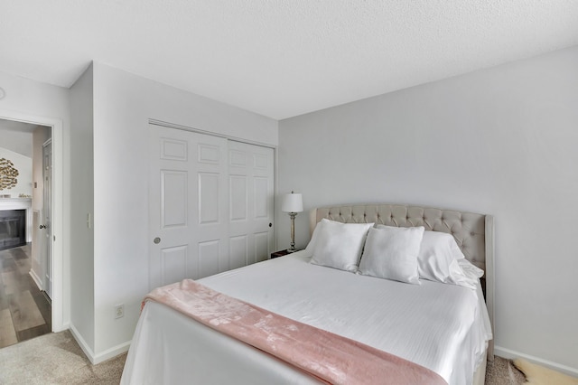 7838 Long Shadow Ln, North Charleston, SC 29406 - bedroom with a closet, light colored carpet, baseboards, and a glass covered fireplace