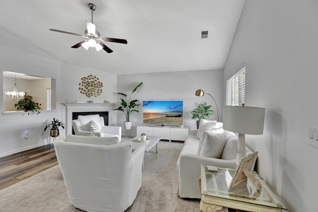 7838 Long Shadow Ln, North Charleston, SC 29406 - living area with vaulted ceiling, a chandelier, ceiling fan, baseboards, and light wood-style flooring