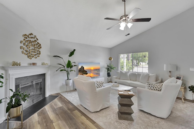 7838 Long Shadow Ln, North Charleston, SC 29406 - living area featuring lofted ceiling, wood finished floors, ceiling fan, a glass covered fireplace, and baseboards