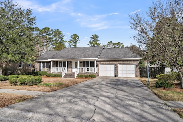 ranch-style home with aphalt driveway, brick siding, roof with shingles, covered porch, and a garage