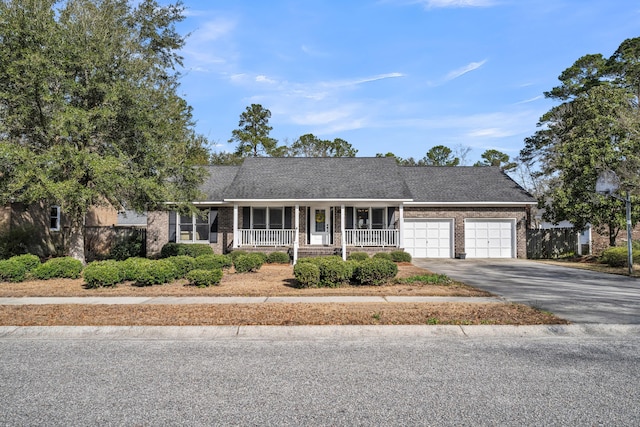 single story home featuring an attached garage, covered porch, brick siding, a shingled roof, and driveway