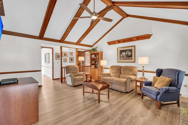 living room with ceiling fan, high vaulted ceiling, light wood-type flooring, beamed ceiling, and baseboards