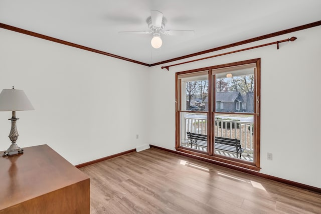 unfurnished room with baseboards, crown molding, a ceiling fan, and light wood-style floors