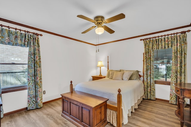 bedroom featuring light wood-style floors, ceiling fan, baseboards, and crown molding