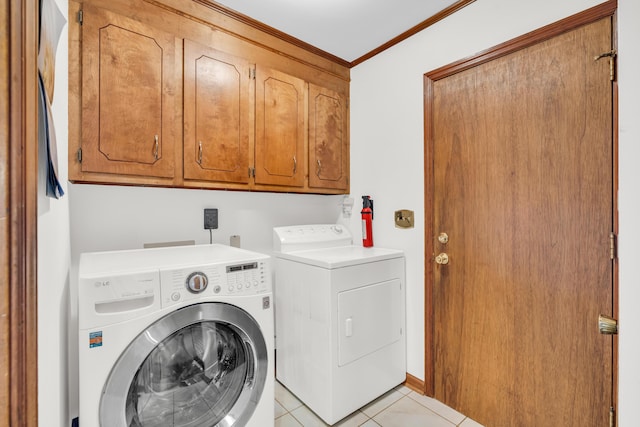 laundry area featuring light tile patterned floors, cabinet space, crown molding, and separate washer and dryer