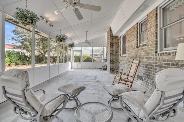 sunroom with a ceiling fan and vaulted ceiling