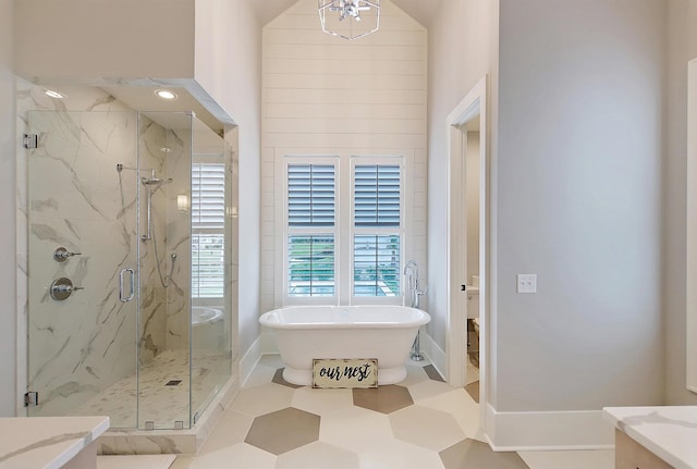 bathroom with shower with separate bathtub, a towering ceiling, tile patterned floors, and vanity