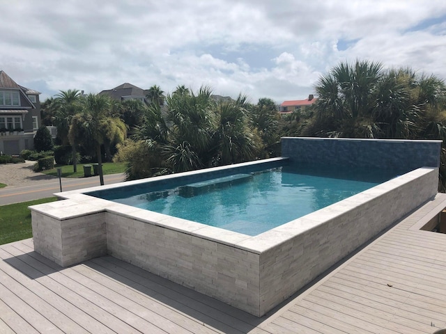 view of swimming pool featuring a deck