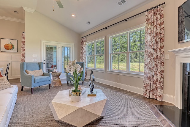 living area featuring healthy amount of natural light, a ceiling fan, wood finished floors, baseboards, and recessed lighting