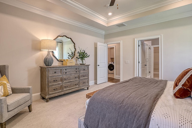bedroom with crown molding, light carpet, washer / clothes dryer, baseboards, and connected bathroom