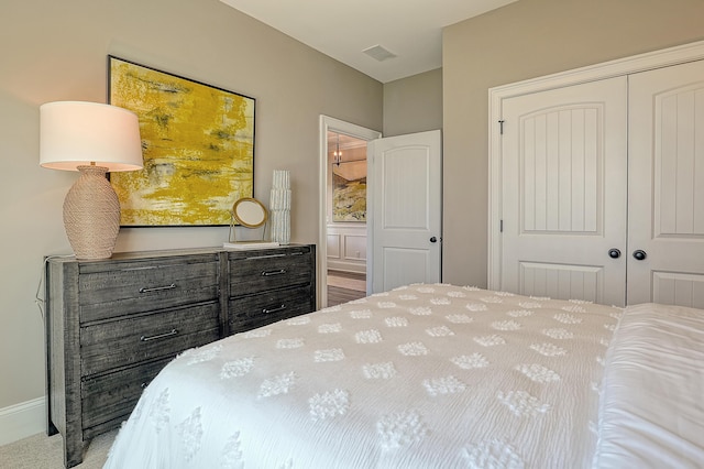 bedroom featuring a closet, baseboards, and carpet flooring