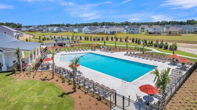 community pool featuring a residential view and a patio area