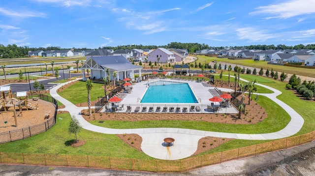 community pool featuring a residential view and a patio