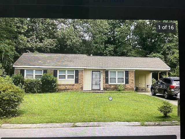 ranch-style house with a front lawn and a carport