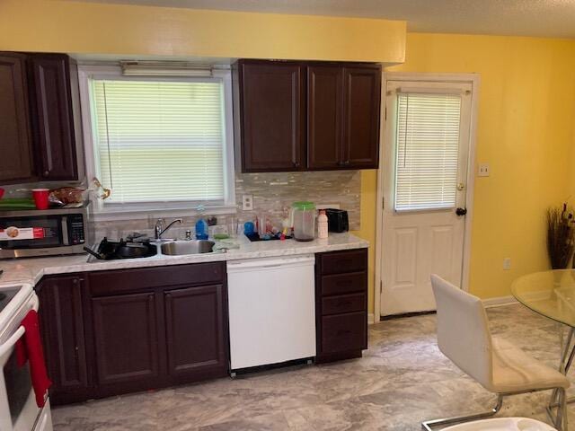 kitchen with dishwasher, sink, electric range, decorative backsplash, and dark brown cabinets