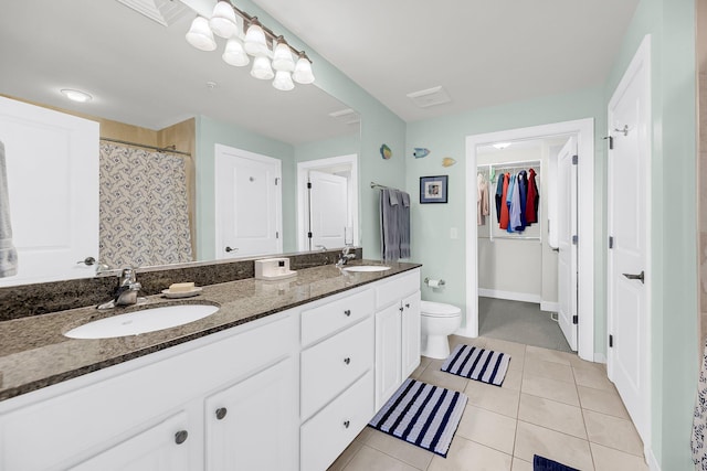 bathroom featuring vanity, toilet, and tile patterned floors