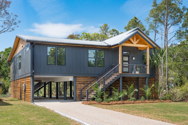 1014 E Erie Ave, Folly Beach, SC 29439 - view of front of property featuring a carport, stairs, driveway, and covered porch