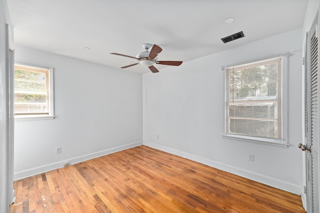 spare room with light wood-type flooring and ceiling fan