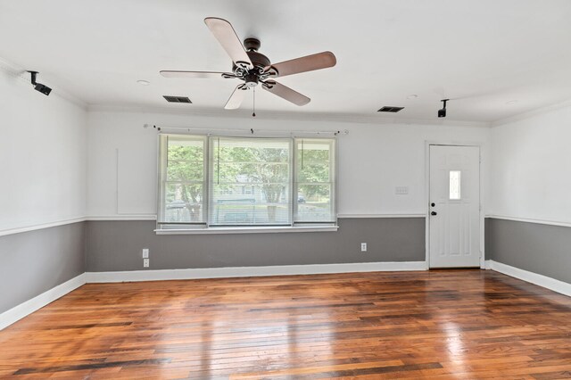 unfurnished room featuring ceiling fan, dark hardwood / wood-style flooring, and crown molding