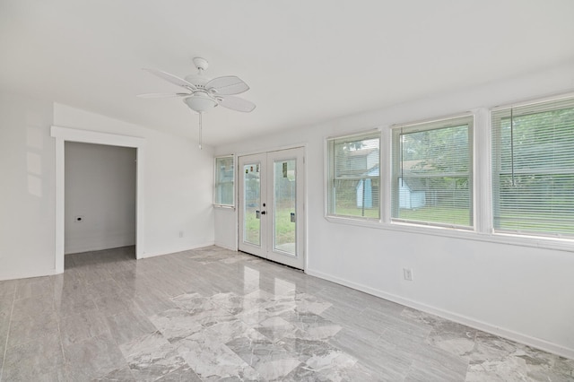 spare room featuring french doors, lofted ceiling, ceiling fan, and a healthy amount of sunlight