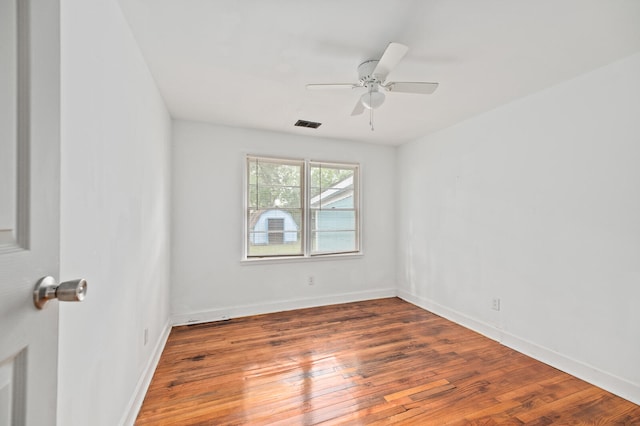 empty room featuring ceiling fan and hardwood / wood-style flooring