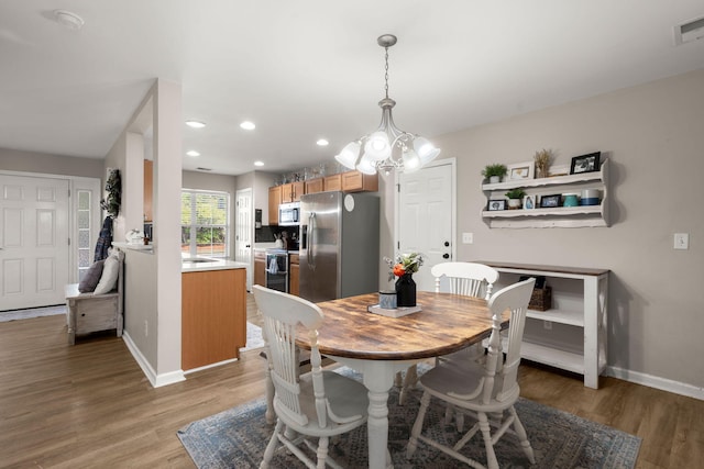 dining room featuring hardwood / wood-style floors and a notable chandelier