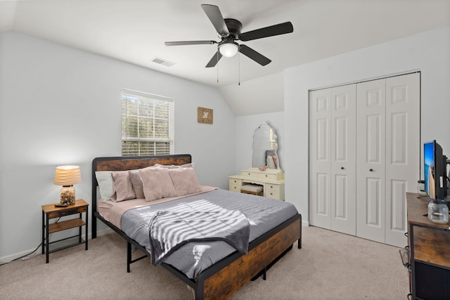 carpeted bedroom featuring a closet, ceiling fan, and lofted ceiling