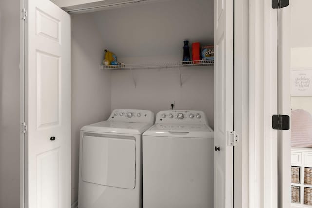 clothes washing area with washer and clothes dryer