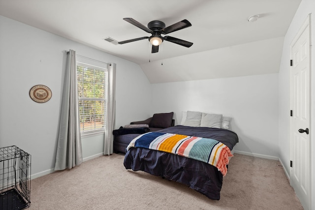 bedroom with ceiling fan, light colored carpet, and multiple windows