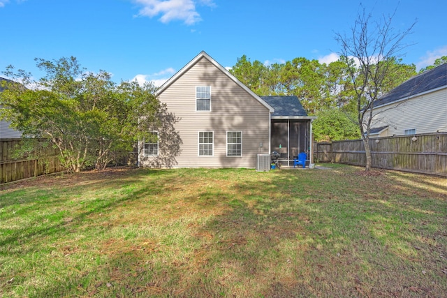 back of property with cooling unit, a lawn, and a sunroom