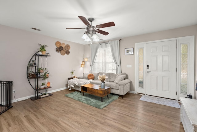 living room featuring hardwood / wood-style floors and ceiling fan