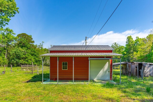 view of outbuilding featuring a yard