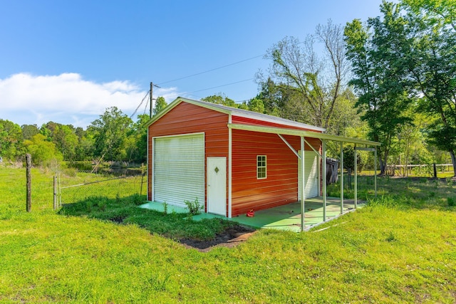 view of outbuilding with a garage and a lawn