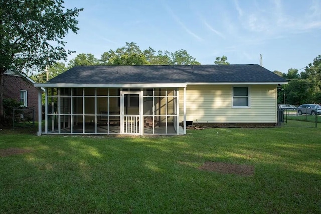 rear view of property featuring a yard